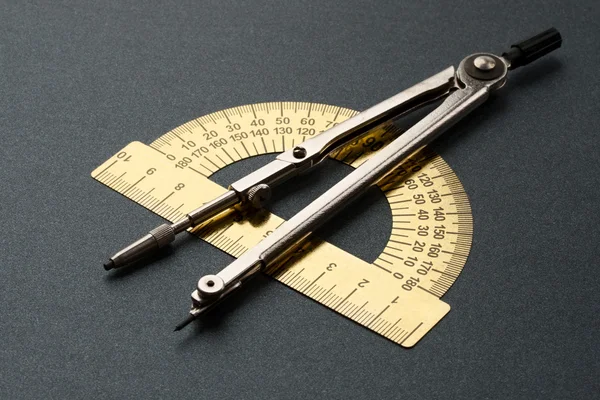 Pair of compasses and protractor — Stock Photo, Image