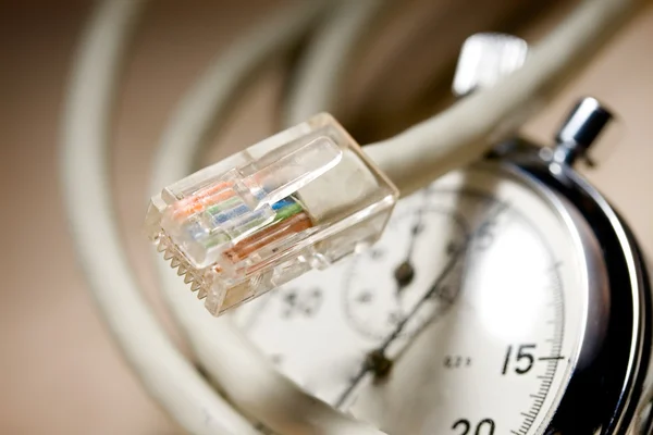 Ethernet cable and stopwatch — Stock Photo, Image