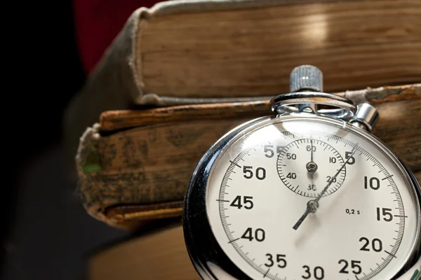 Pile of old books and stopwatch — Stock Photo, Image