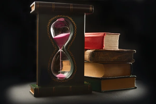 stock image Old books and sand glass