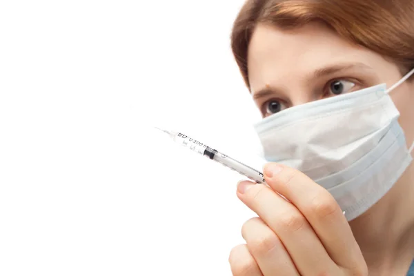 Woman in mask holding syringe — Stock Photo, Image