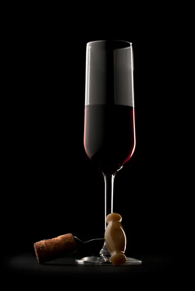 Glass of red wine with corkscrew — Stock Photo, Image