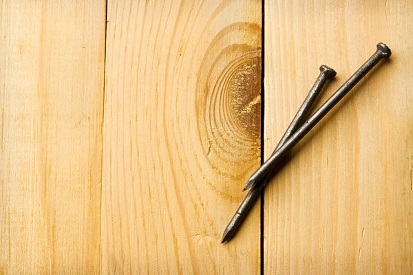 Nails isolated on wooden background — Stock Photo, Image