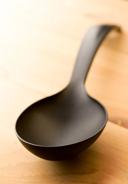 Spoon isolated on wooden background — Stock Photo, Image