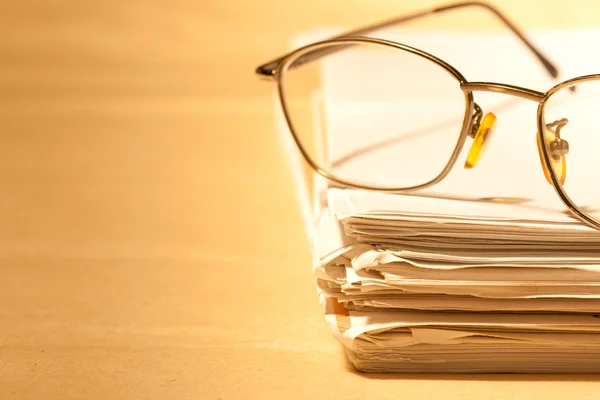 stock image Stack of papers and glasses