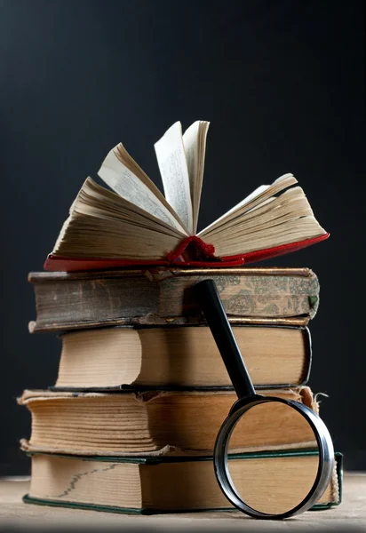 stock image Old books with magnifying glass