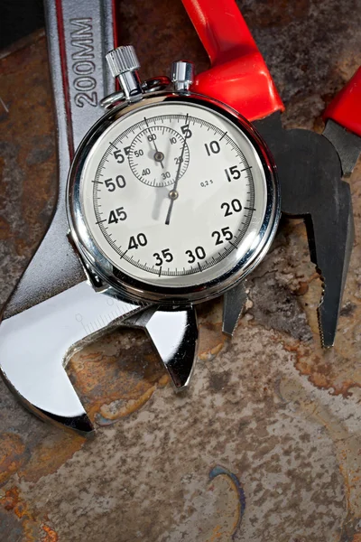 Spanner, pliers and stopwatch — Stock Photo, Image