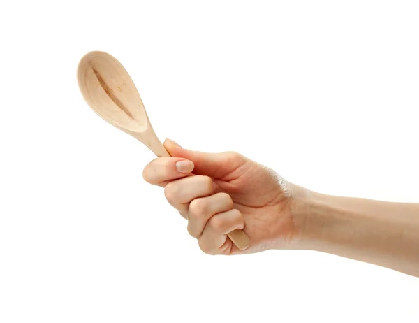 Wooden spoon in female hand — Stock Photo, Image