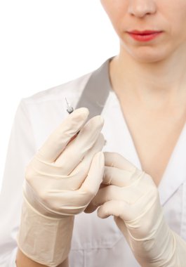 Nurse's hands in sterile gloves with syringe clipart