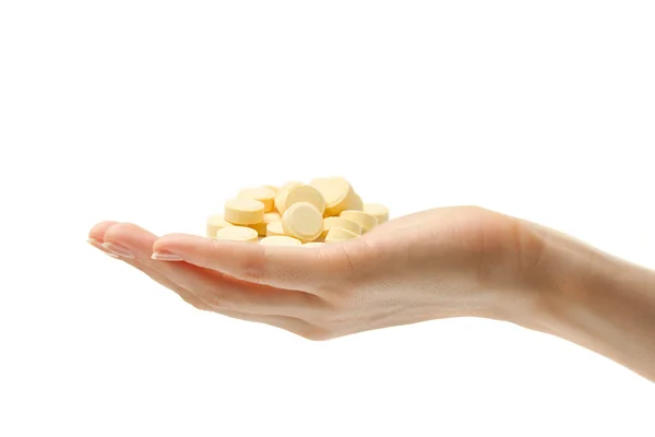 Ręka z żółte tabletki — Zdjęcie stockowe