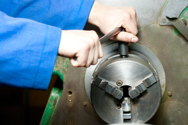 Regulating of turning lathe with hands — Stock Photo, Image