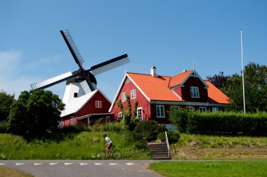 Windmill in Arsdale and cyclist. clipart