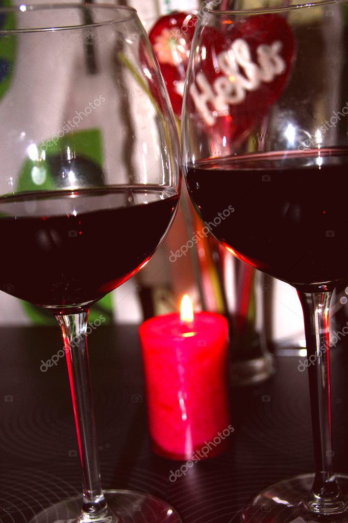 Two glasses of red wine next to the candles — Stock Photo © Metanna