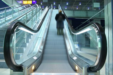 Person climbing on escalator clipart