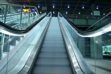 Ascending escalator in a public transport area clipart