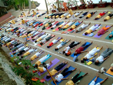 Yoga Class in Sivananda ashram in Neyyar Dam, Kerala, India clipart