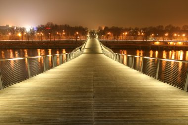 Simon de beauvoir footbridge at night, paris, france clipart