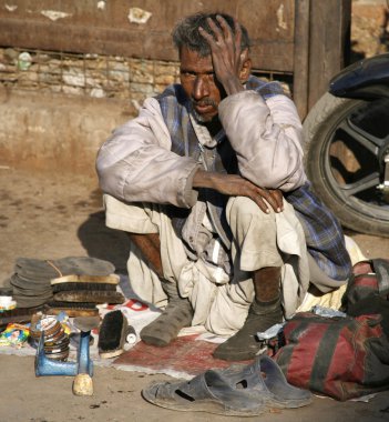 Shoe shiner at Jama Masjid, Delhi, India clipart