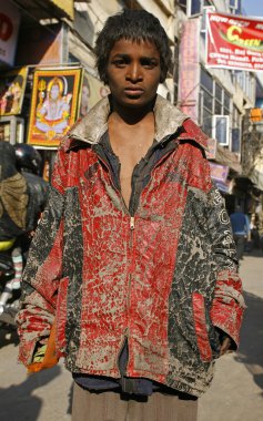 Young beggar boy in paharganj delhi, india clipart