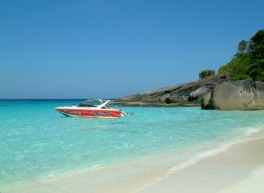 Red speed boat moored on beach, similan islands, thailand clipart