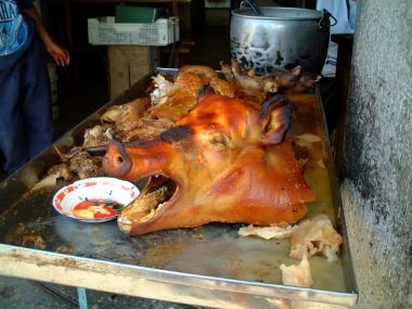 Grilled pig head with mouth open, banos, ecuador clipart