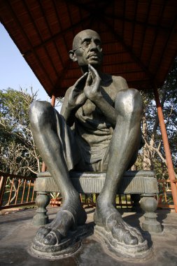 Gandhi statue at rajghat memorial in new delhi, india clipart
