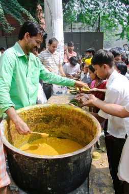 Child beggars receiving food clipart