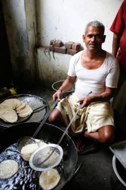 Man making puri clipart