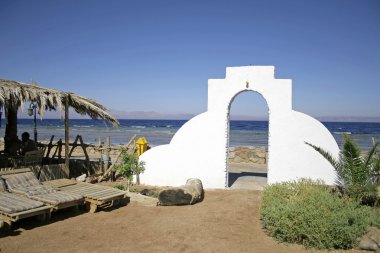 Door archway into bedouin style guesthouse in dahab, red sea, sinai, egypt clipart