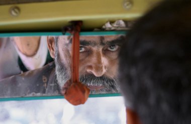 Bearded auto-rickshaw driver in delhi, india clipart