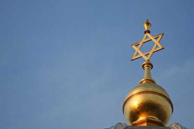 Golden star of david on a blue sky in berlin, germany clipart