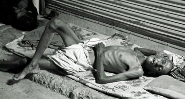 Old man sleeping on footpath, delhi, india clipart