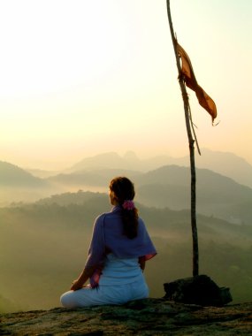 Lady meditating at sunrise clipart