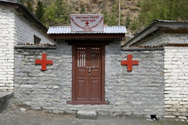 Small red cross dispensary on the annapurna circuit, nepal clipart