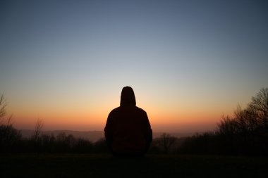 Silhouette of meditating person clipart