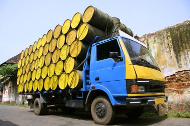 Barrels stacked atop truck, south india clipart