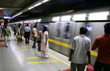 Passengers awaiting metro train, delhi, india clipart