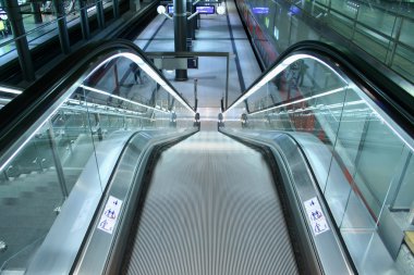 Descending escalator in a public transport area clipart