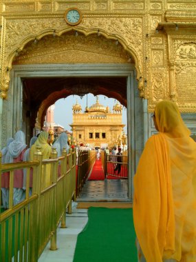 Sikh ladies entering the Golden Temple, amritsar, india clipart