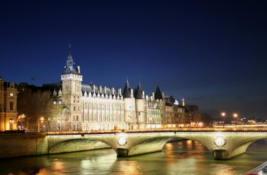 La conciergerie at night with pont de l'horloge in foreground, paris, clipart