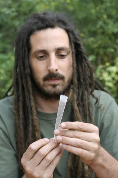 Hippy preparing, rolling and smoking marijuana joint : photos series — Stock Photo, Image