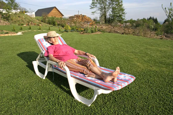 Woman pensioner enjoying her free time in garden — Stock Photo, Image