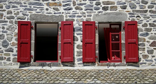 Två fönster med röda fönsterluckor — Stockfoto