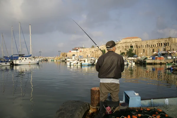 Rod fisherman in akko harbour israel — Stock Photo, Image
