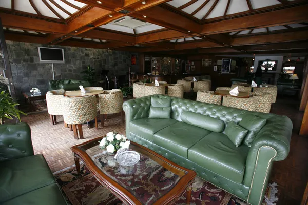 Green leather sofa in luxurious bar in hotel — Stok fotoğraf