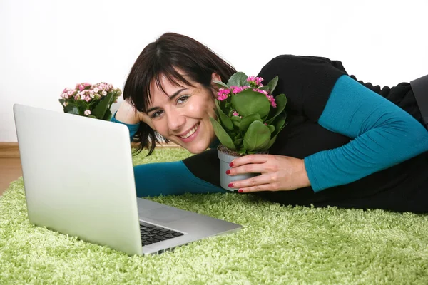 Woman flowers and laptop — Stock Photo, Image
