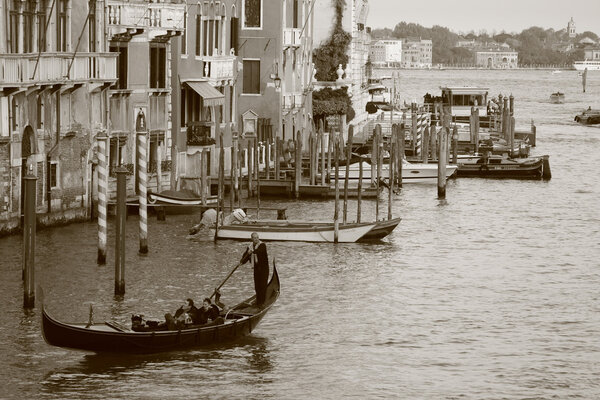 VENICE - OCTOBER 28: (Shot as Sepia) Couple on gondola ride on October 28, 2009 in Venice. Thousands of gondolas navigated in the 18th century, with only severa