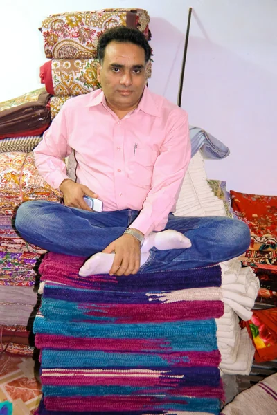 Man sitting on fabric — Stock Photo, Image
