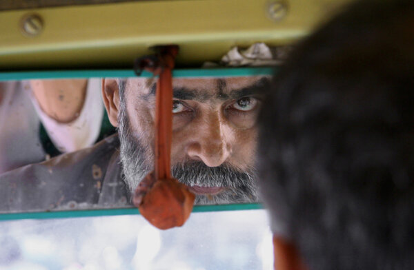 Bearded auto-rickshaw driver in delhi, india