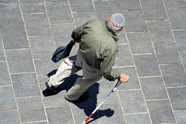 Old man with wlaking stick wearing jewish kippa, jerusalem, israel